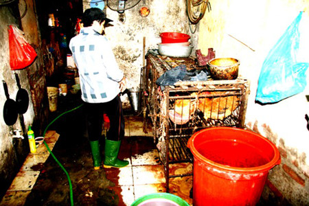Lò giết mổ gia cầm nằm trong nhà vệ sinh 3 Dụng cụ giết mổ, thùng đựng nước nóng, lồng nhốt, bếp đung phủ kín cáu bẩn.